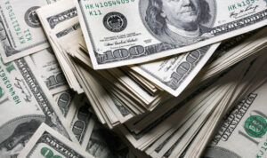 stack of one hundred dollars notes on dollars background